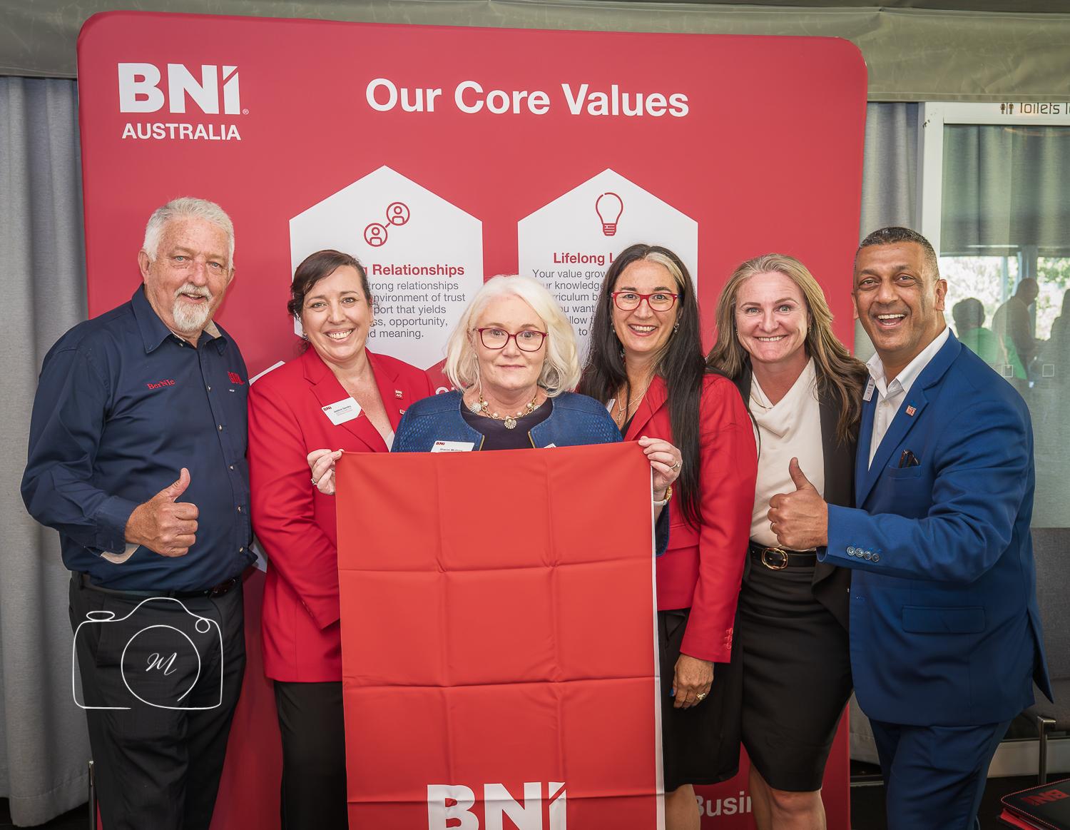 BNI Brisbane West members celebrating core values at a networking event, showcasing membership benefits and community spirit.