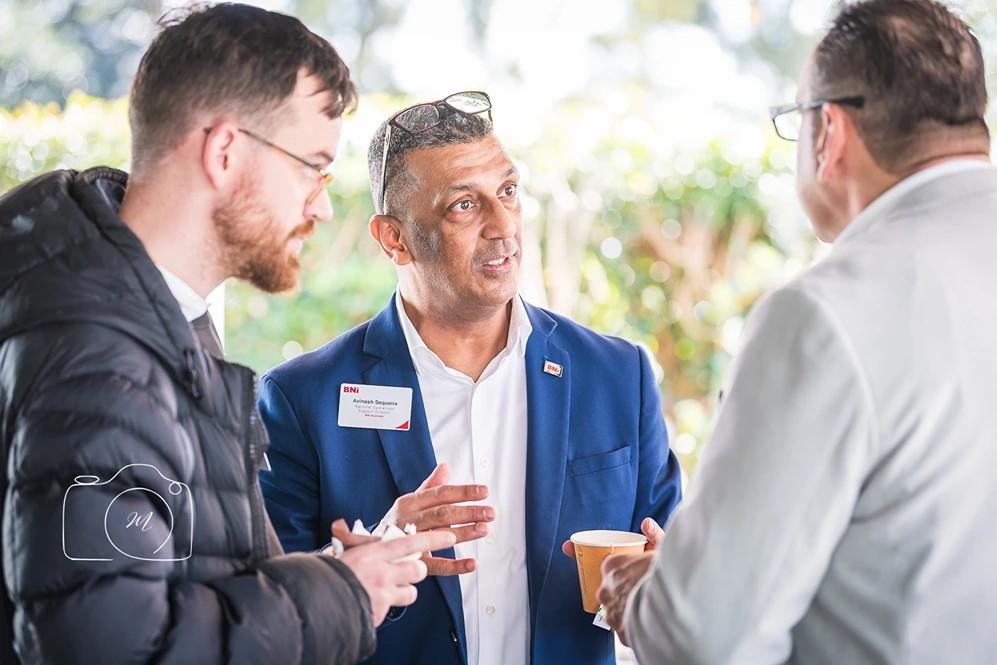 BNI Brisbane West business networking conversation at professional meeting event featuring members building partnerships and discussing referrals in Brisbane